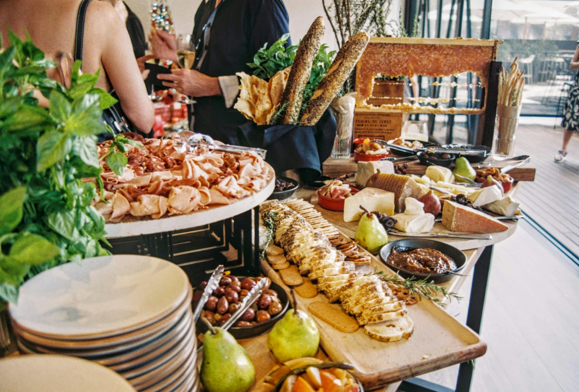 A spread of catered food displayed on a table at an event